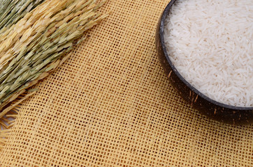 Jasmine rice in a coconut shell with Straw and copy space