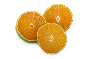 green tangerine slice isolated on white