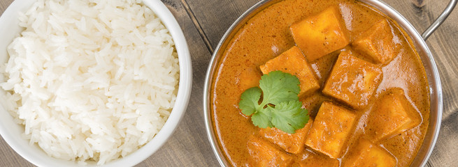 Paneer Makhani or Shahi Paneer (Paneer Butter Masala) - Indian curd cheese curry served in a balti dish and garnished with coriander leaves. Shot from above (overhead).