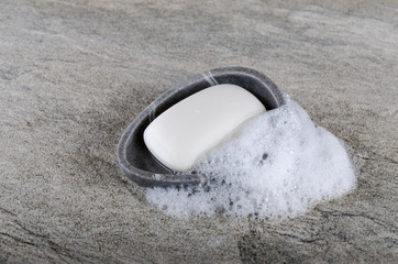 Wet soap with foam in soap dish