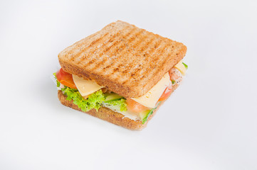 Close up sandwich with salmon, fresh tomatoes and cucumber, cheese and lettuce with toasted bread. Isolated on the white background, selective focus