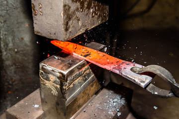 Forging molten metal. Making knives.