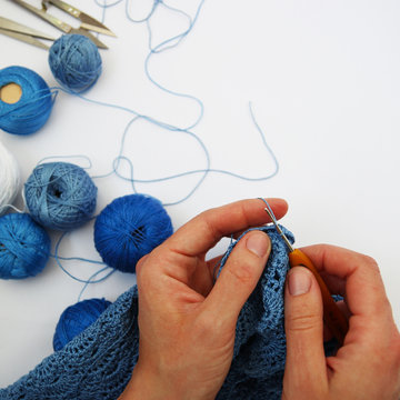 Hands of a woman knit a dress