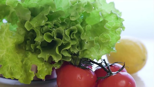 Fresh lettuce salad falls under water with a splash. Super slow motion
