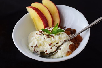 Healthy breakfast: cottage cheese with flax seeds, raisins, fresh apples. Healthy eating concept