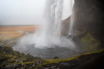 Seljalandsfoss waterfall in southern Iceland on a cloudy winter day. It is one of the largest waterfalls in the country.  
