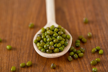 green mung beans on wooden surface