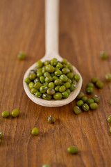 green mung beans on wooden surface