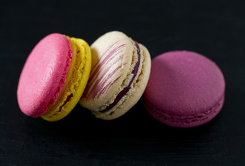 assorted macaroons on black chalkboard