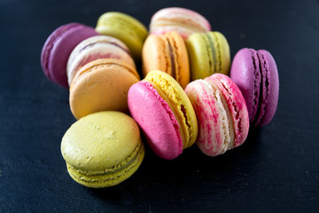 assorted macaroons on black chalkboard