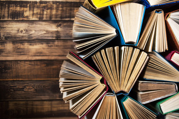 Books on the wooden table, open book