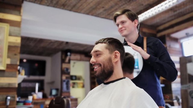 man and hairdresser with mirror at barber shop