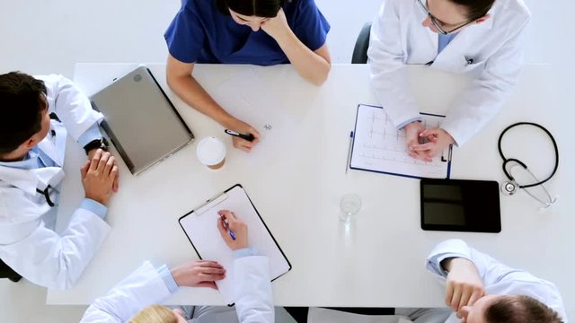group of doctors with cardiogram at hospital