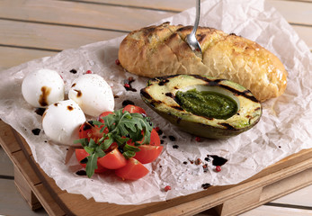 Avocado toast, cherry tomato and poached eggs on wooden background. vegetarian food, healthy diet concept.