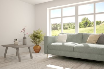 White room with sofa and green landscape in window. Scandinavian interior design. 3D illustration
