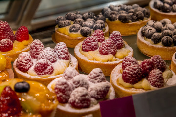 Cake with fresh berries on shop window