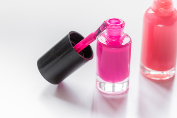 collection of nail polish on white desk background