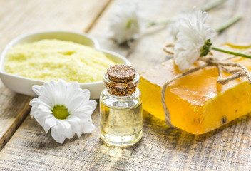 Obraz na płótnie Canvas organic cosmetics with camomile extract on wooden table background