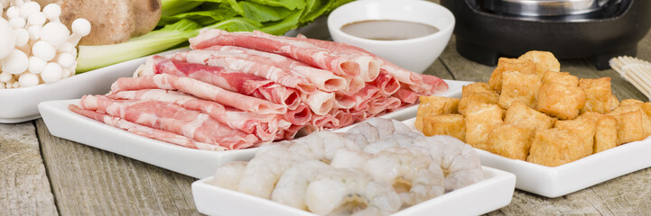 Szechuan Hot Pot Ingredients - Spicy Chinese hot pot ingredients including beef, tofu, prawns, mushrooms, green leaves and noodles.