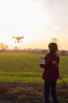 Girl With Drone Flying At Sunset