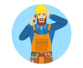 Worker talking on the mobile phone and grabbed his head