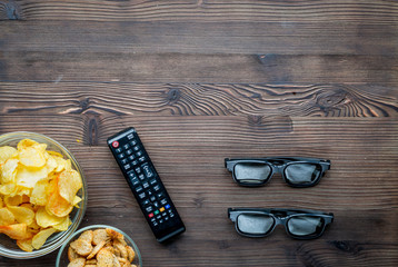 watching movies concept with chips on wooden background top view mock up