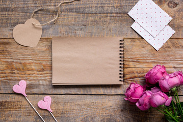 Mother's day gift with peony flowers and notebook top view mockup
