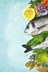 Uncooked organic dorado or sea bream with ingrediets for making.Top view with copy space.