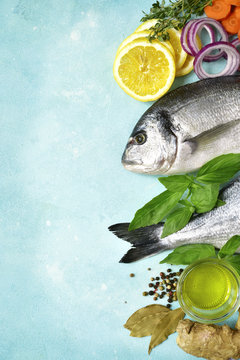 Uncooked organic dorado or sea bream with ingrediets for making.Top view with copy space.