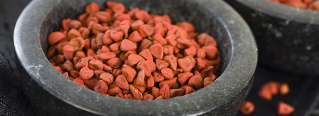 Annatto Seeds - Annatto (achiote) seeds in a black bowl.