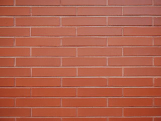 Obraz premium Brown orange brick wall staggered stacked