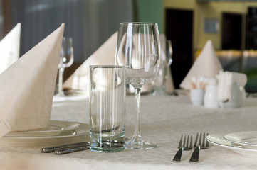 catering table set service with silverware, napkin and glass at restaurant before party