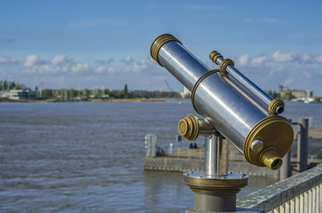 Obraz na płótnie Canvas View of the Shelda River from the viewing platform of the wharf of Antwerp. Telescope with landscape