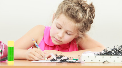 Little girl draw in the classroom