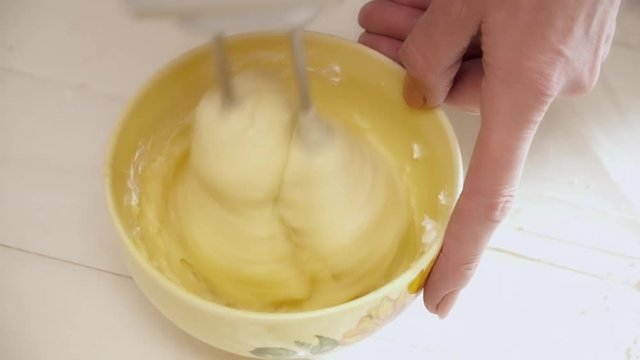 Woman's hands prepering the cream for the eclairs clsoeup