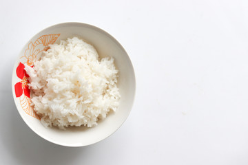 Rice cooked in bowl on white background