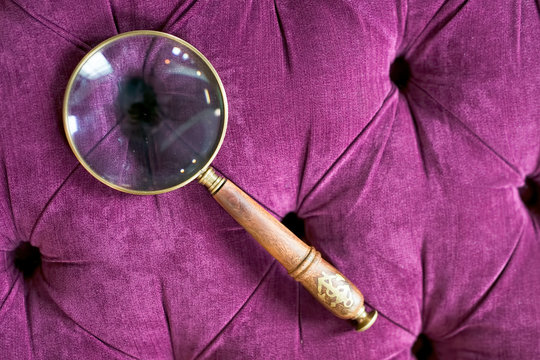 Magnifying glass on Purple Couch