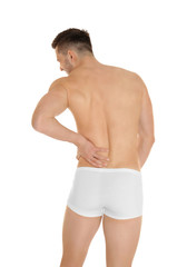 Fototapeta premium Young man suffering from back pain on white background