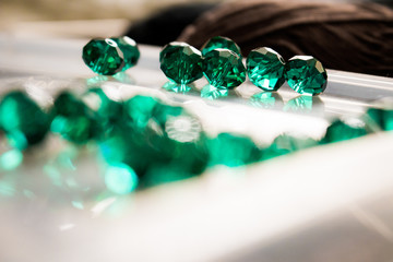 Still life of glass beads at working table.
