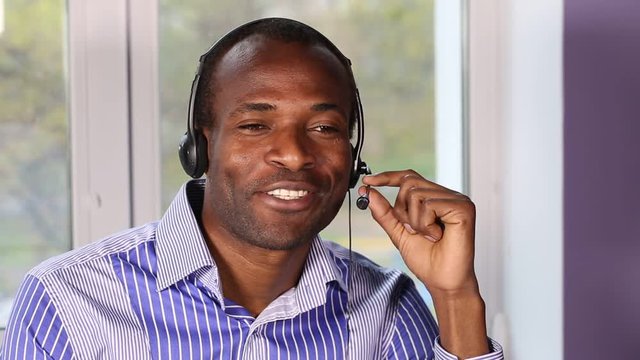 Call Center Works With the Client. Hot-line operator with headphones consulting clients. This video was shot using Canon 5d Mark 3. 