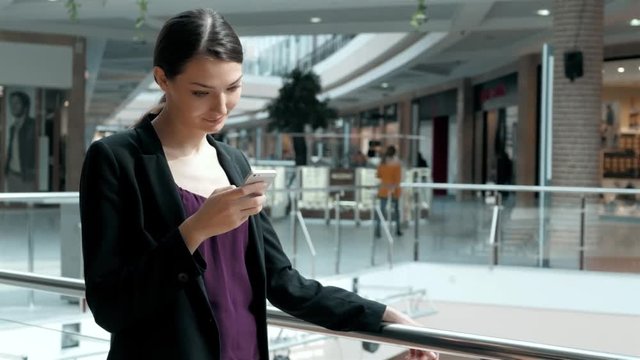 portrait young adult girl with smartphone in shopping mall, business woman in modern office with sun light