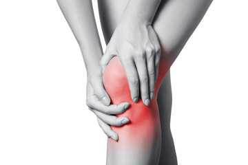 Closeup view of a young woman with knee pain. isolated on white background. Black and white photo with red dot. - obrazy, fototapety, plakaty