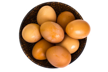 Chicken eggs in wooden bowl on white background