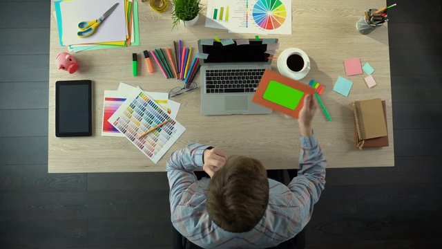 Man talking with wife on phone, looking at her photo, relationship at distance