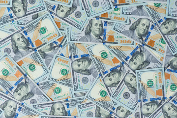 Background from scattered dollar banknotes as abstract seamless.