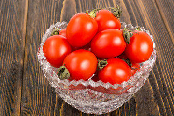 Small red tomatoes in crystal bowl