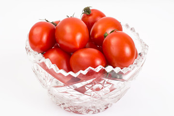 Small red tomatoes in crystal bowl