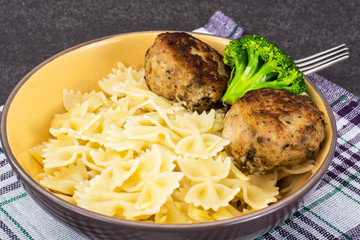 Meat cutlets with farfalle paste for garnish