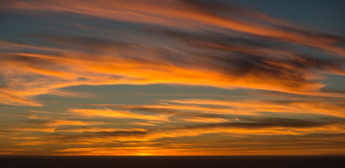 Naklejka na ściany i meble Wispy Sunset Clouds over the Ocean