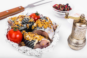 Mackerel in mustard sauce in foil for baking